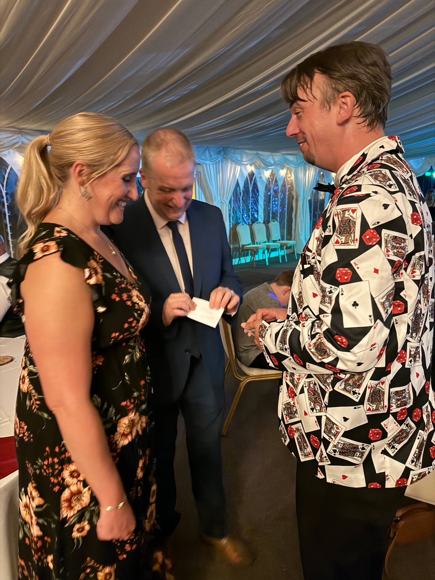 Ash Trix performing close-up magic for guests at a reception