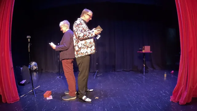 An audience member joins Ash on stage.