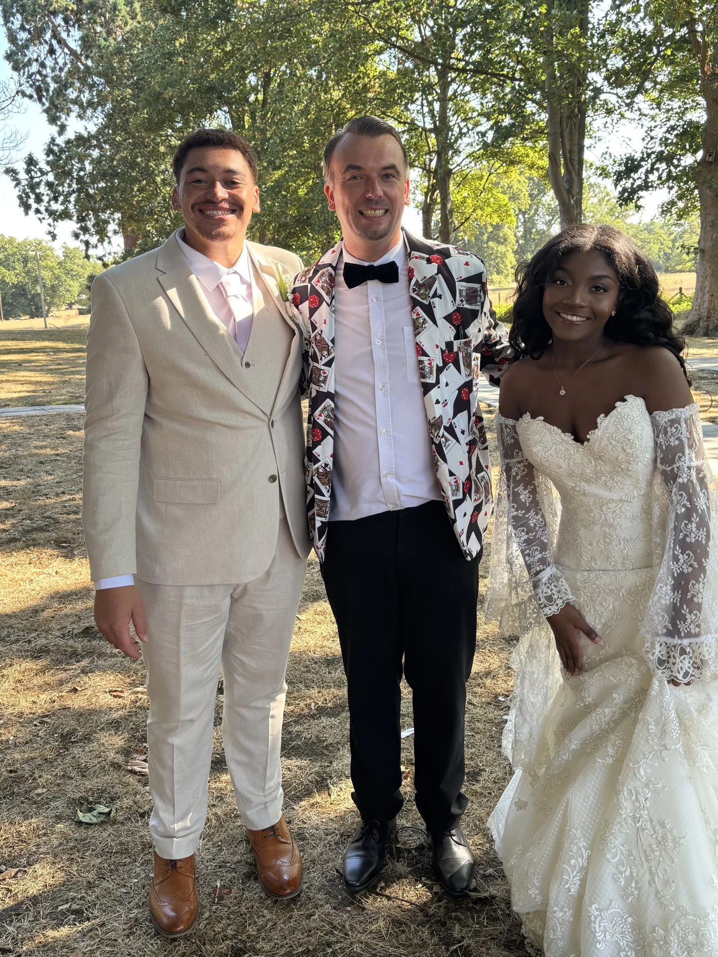 Ash Trix with a bride and groom on their wedding day